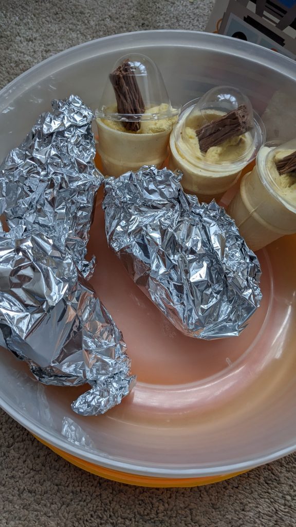 Toddler ice-cream cones ready for the freezer and ones to be wrapped in foil. 